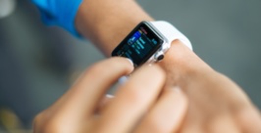 Someone using a smartwatch on their wrist